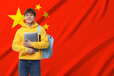 Image of Student with laptop and backpack against flag of China. Language school