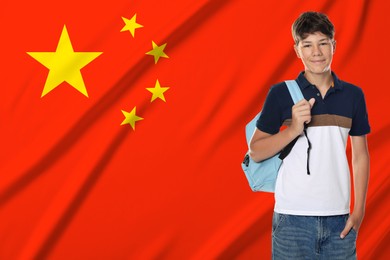 Image of Student with backpack against flag of China. Language school