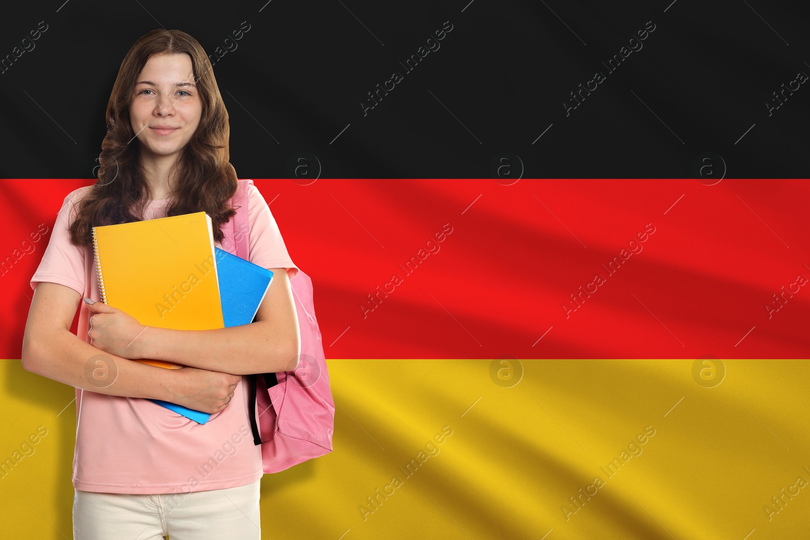 Image of Student with notebooks and backpack against flag of Germany. Language school