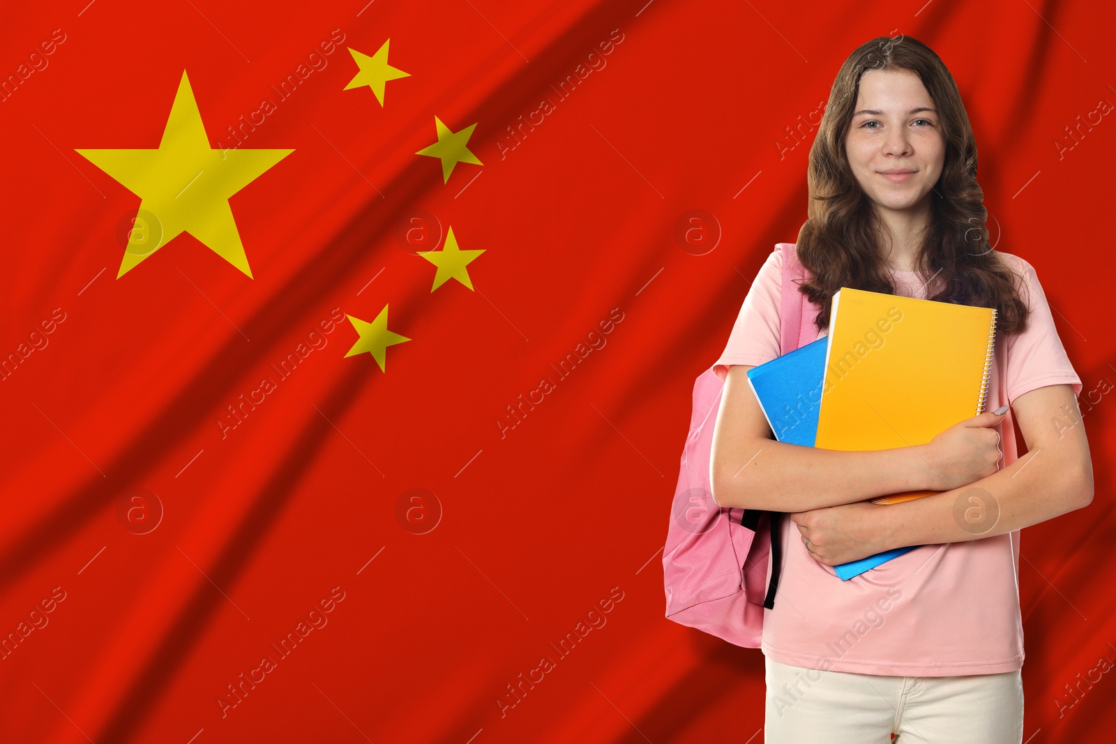 Image of Student with notebooks and backpack against flag of China. Language school