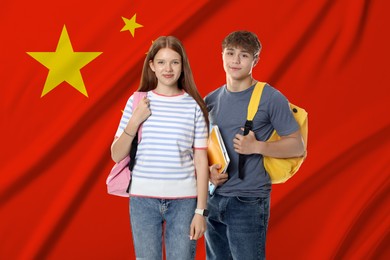 Image of Students with backpacks against flag of China. Language school