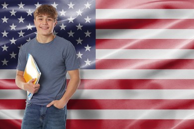 Image of Happy student with notebooks against flag of USA. Language school