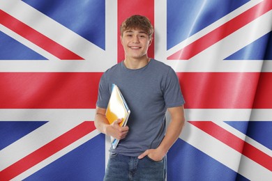 Image of Happy student with notebooks against flag of United Kingdom. Language school