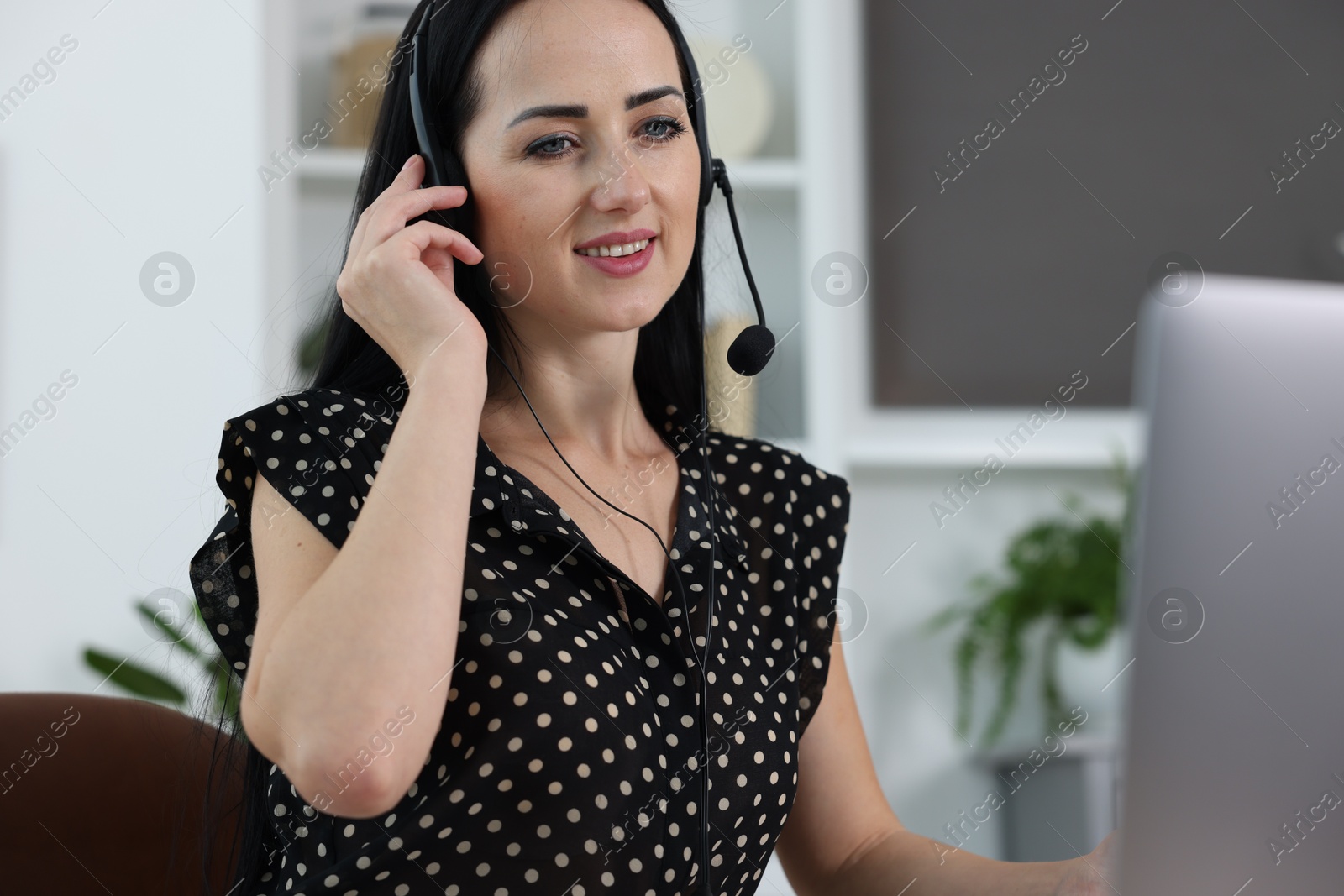 Photo of Woman in headset passing online test via laptop indoors