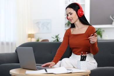 Photo of Woman passing online test on laptop at home