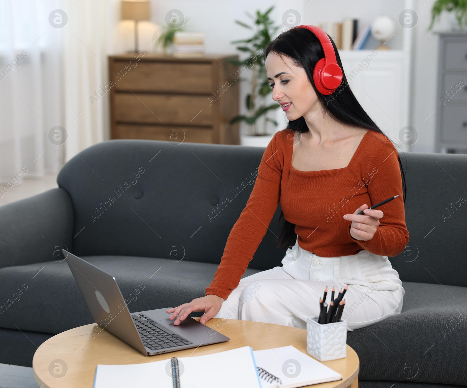 Photo of Woman passing online test on laptop at home