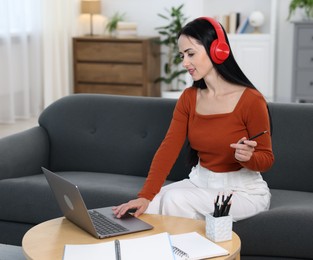 Photo of Woman passing online test on laptop at home