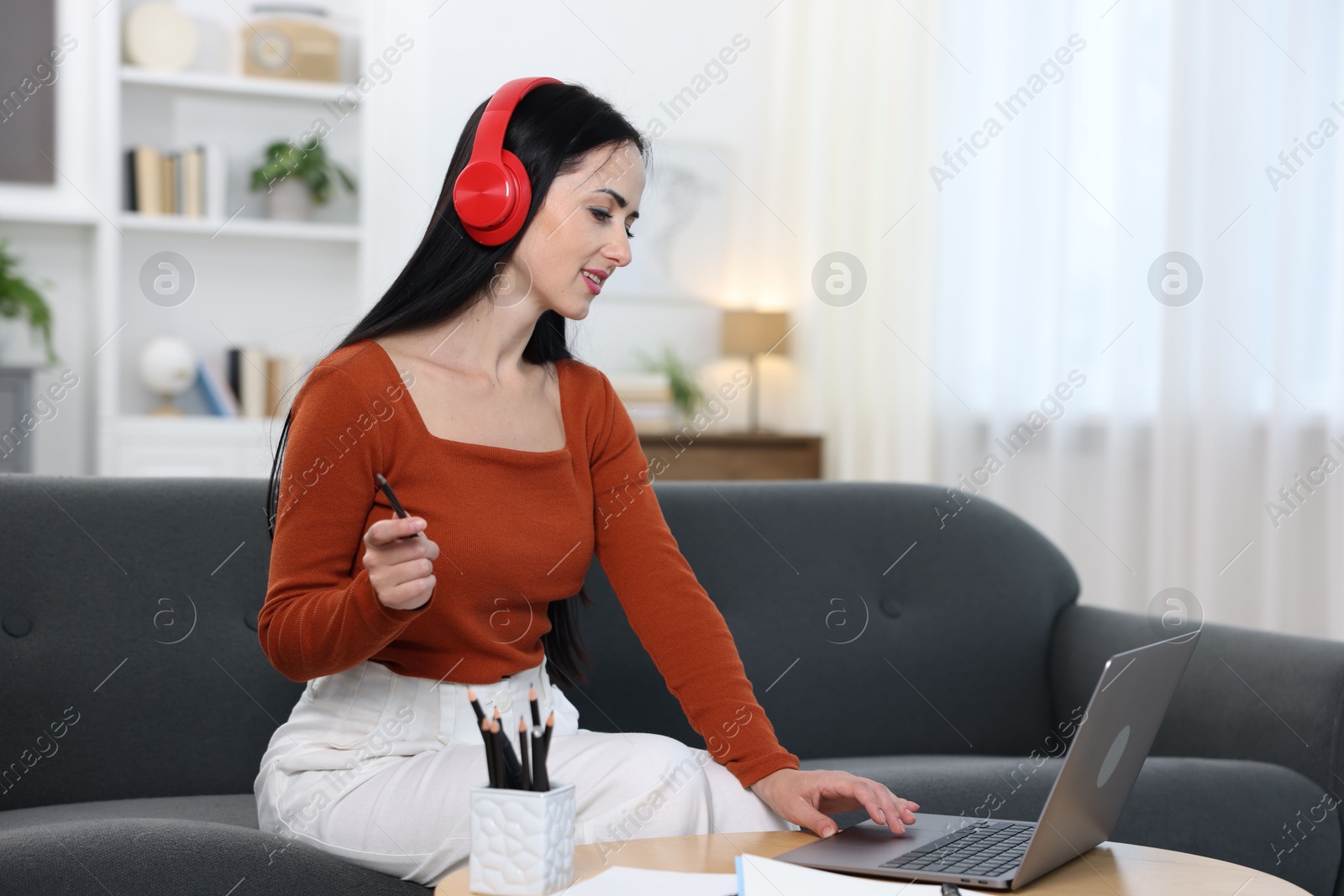 Photo of Woman passing online test on laptop at home