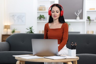 Photo of Woman passing online test on laptop at home