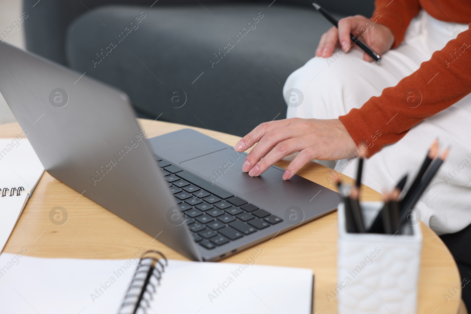 Photo of Woman passing online test on laptop at home, closeup