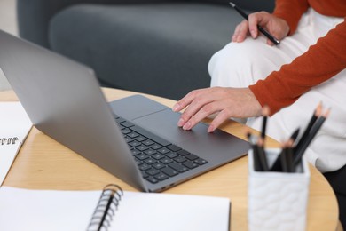 Photo of Woman passing online test on laptop at home, closeup