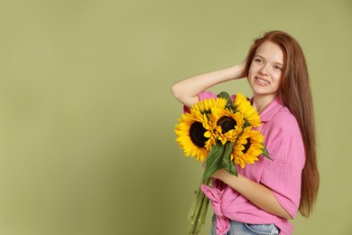 Photo of Teenage girl with bouquet of beautiful sunflowers on green background, space for text