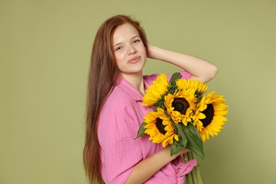 Photo of Teenage girl with bouquet of beautiful sunflowers on green background
