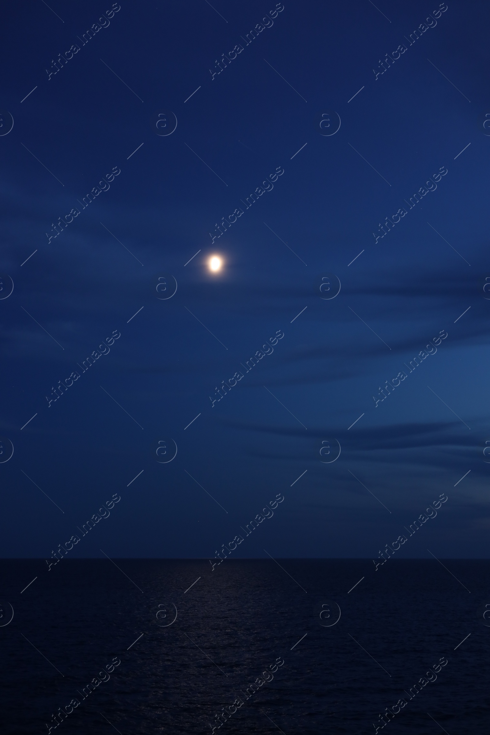 Moon glowing in night sky over beautiful sea Photo of Moon glowing in night sky over beautiful sea