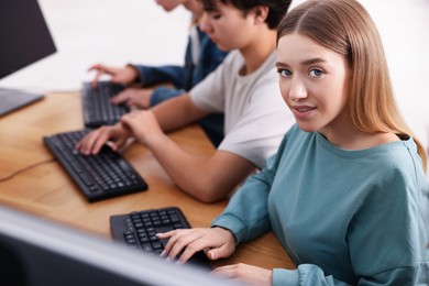 Photo of Students taking online exam indoors, selective focus