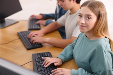 Photo of Students taking online exam indoors, selective focus