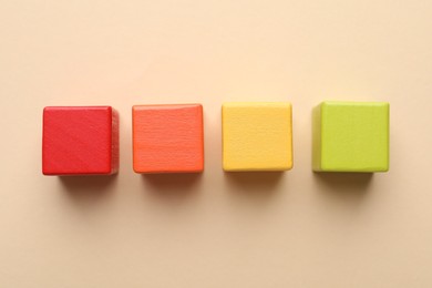 Photo of Colorful cubes on beige background, flat lay