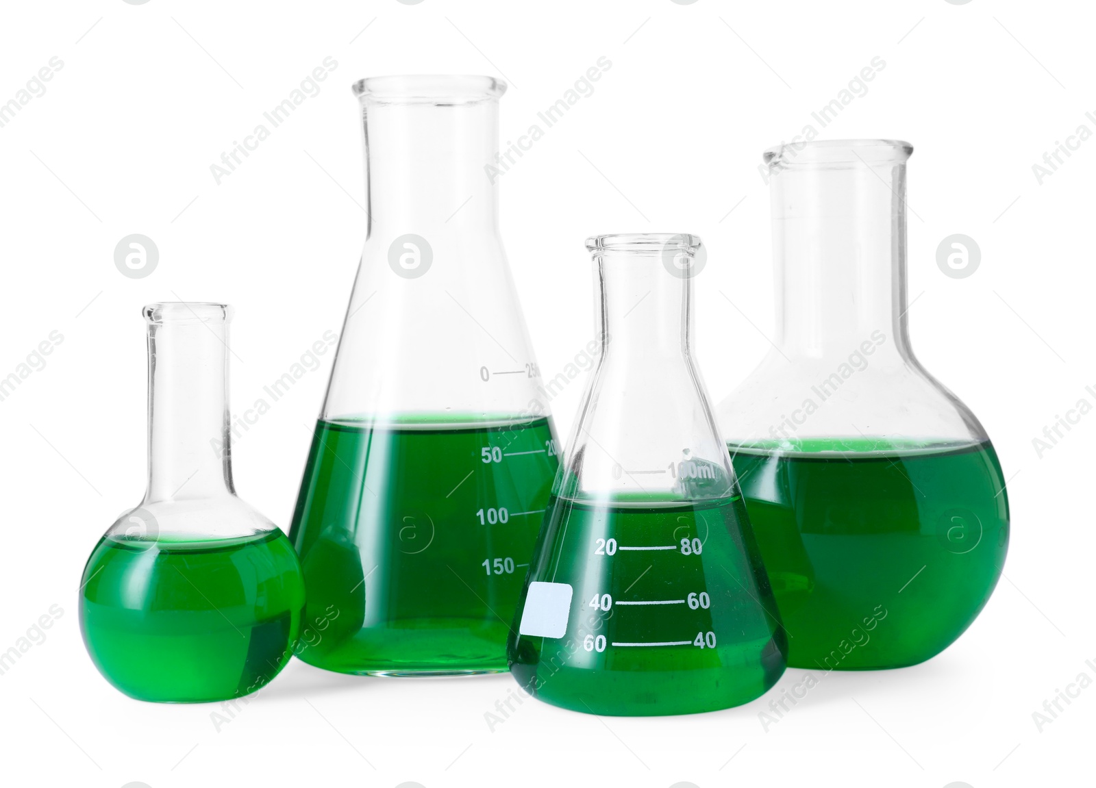 Photo of Different laboratory glassware with green liquid isolated on white