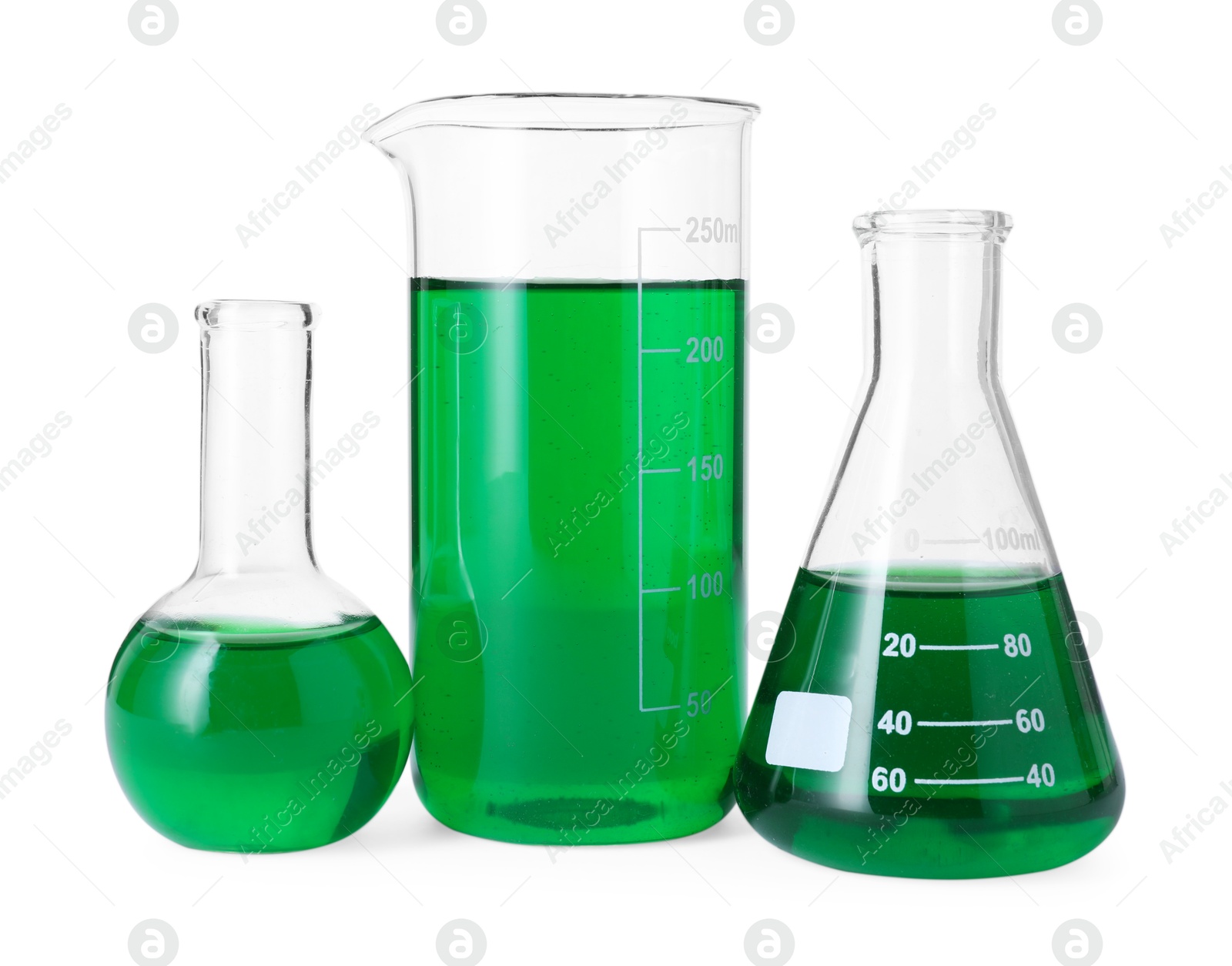 Photo of Different laboratory glassware with green liquid isolated on white
