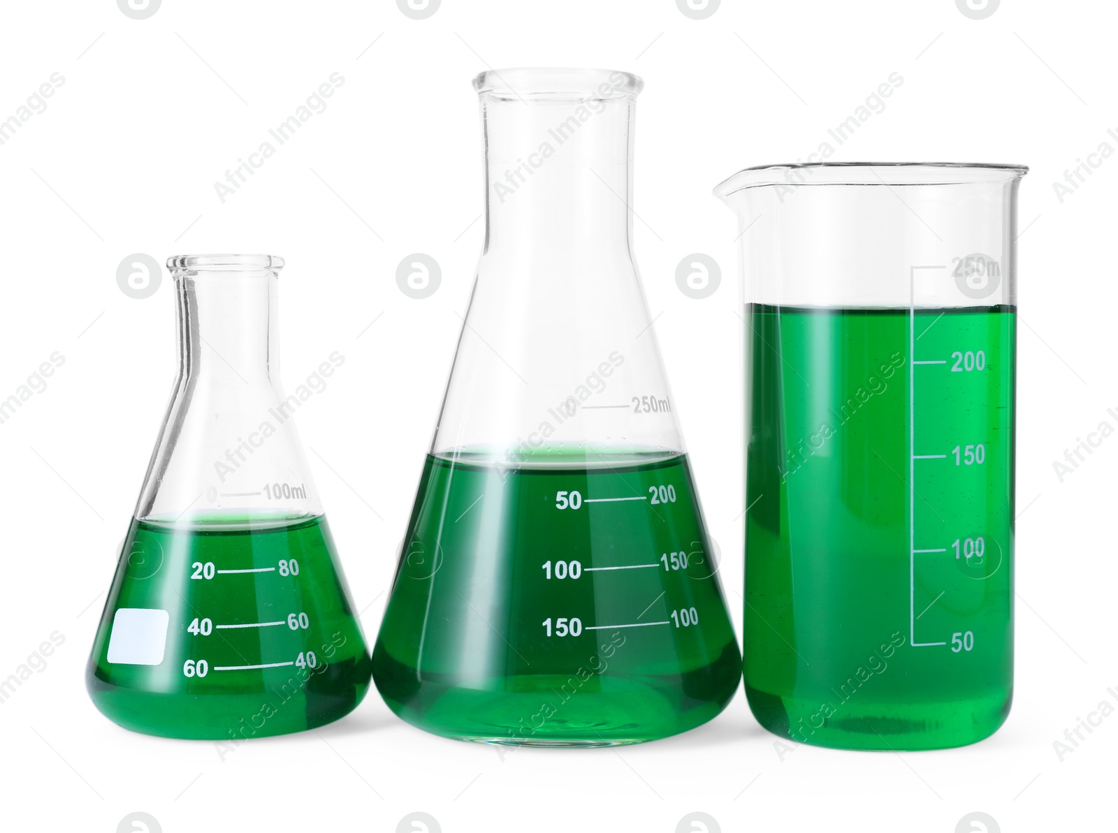 Photo of Different laboratory glassware with green liquid isolated on white