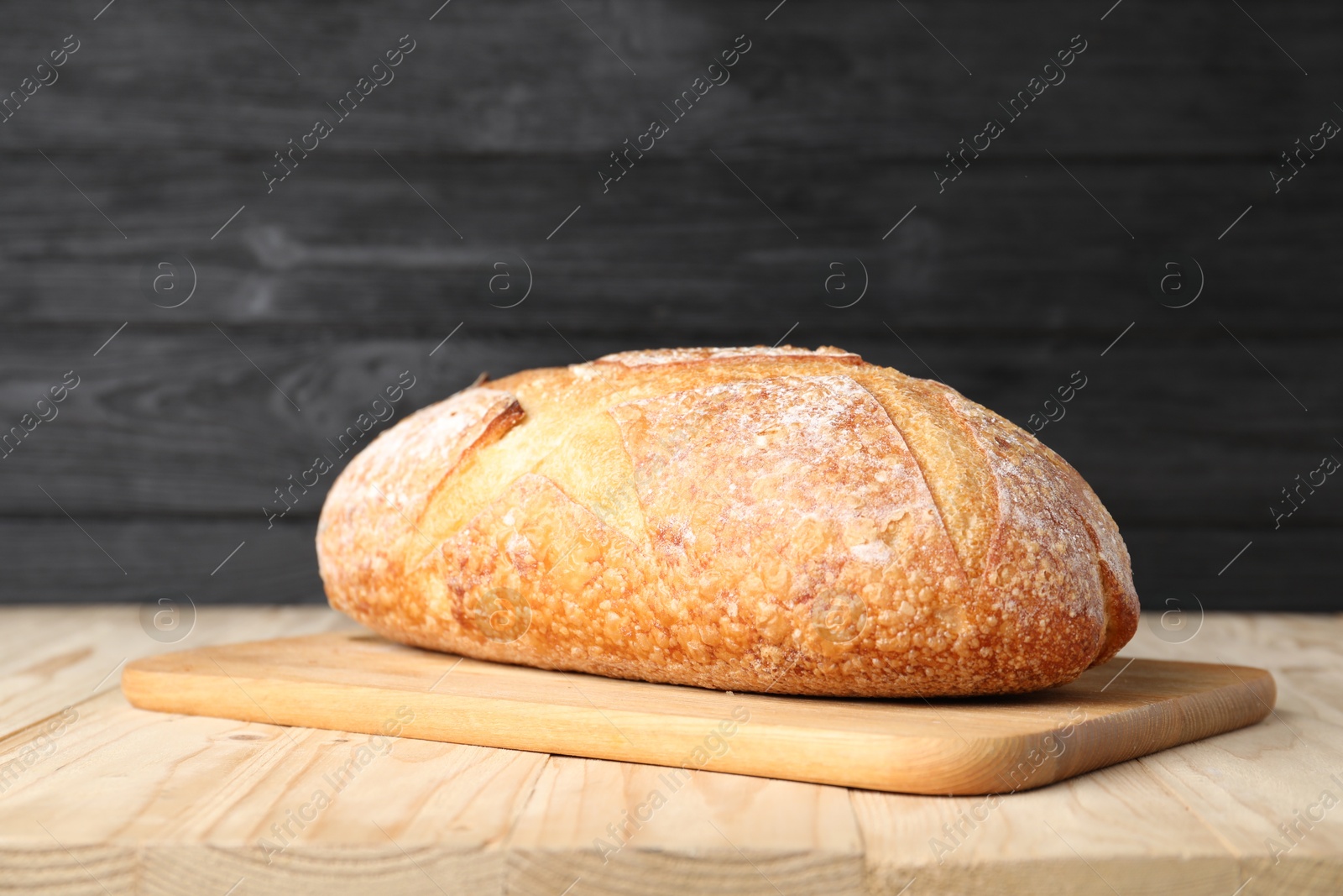 Loaf of fresh bread on light wooden table, closeup Photo of Loaf of fresh bread on light wooden table, closeup