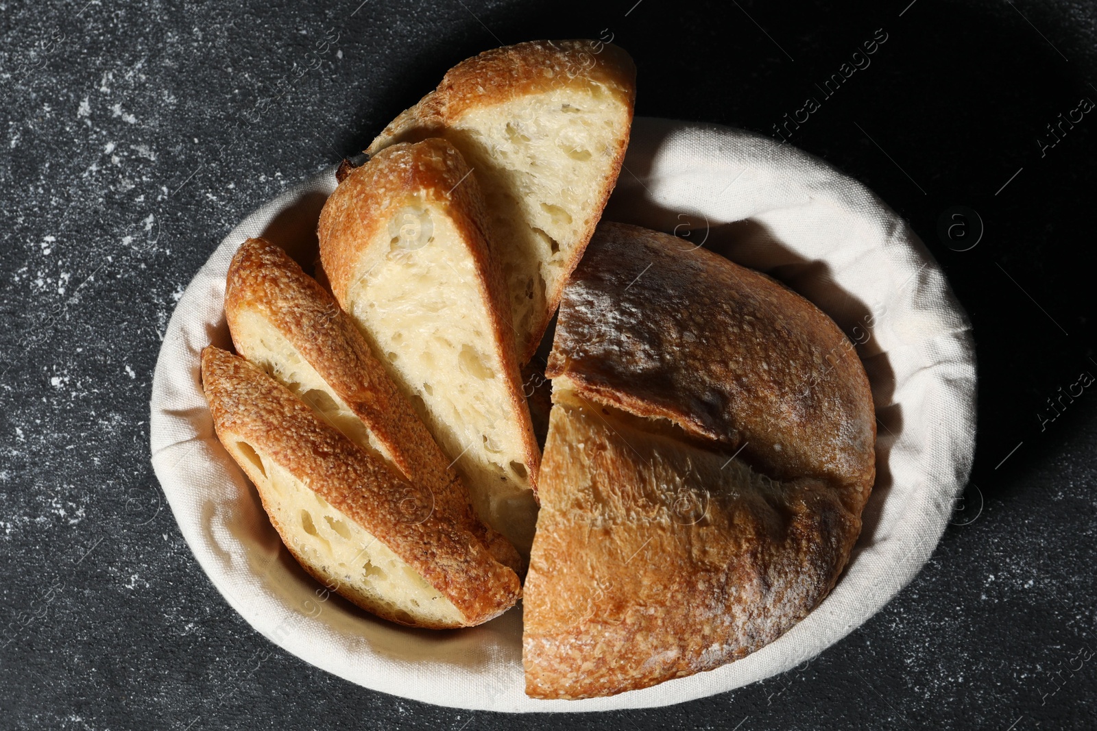 Fresh cut bread on grey textured table, top view Photo of Fresh cut bread on grey textured table, top view