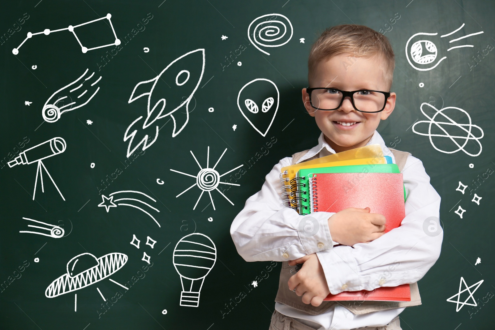 Image of Child wearing eyeglasses near green chalkboard with drawings