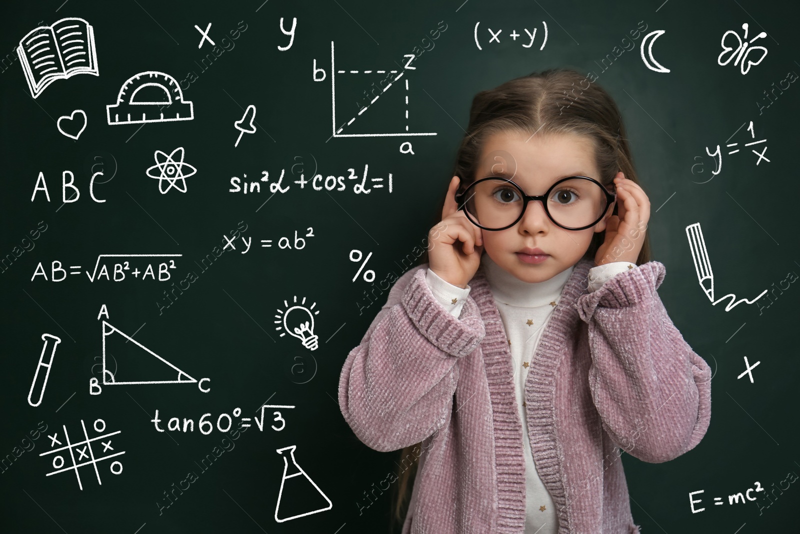 Image of Child wearing eyeglasses near green chalkboard with formulas and drawings