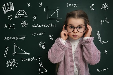 Image of Child wearing eyeglasses near green chalkboard with formulas and drawings
