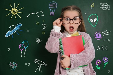 Image of Amused child wearing eyeglasses near green chalkboard with formulas and drawings