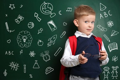 Image of Emotional child near green chalkboard with drawings