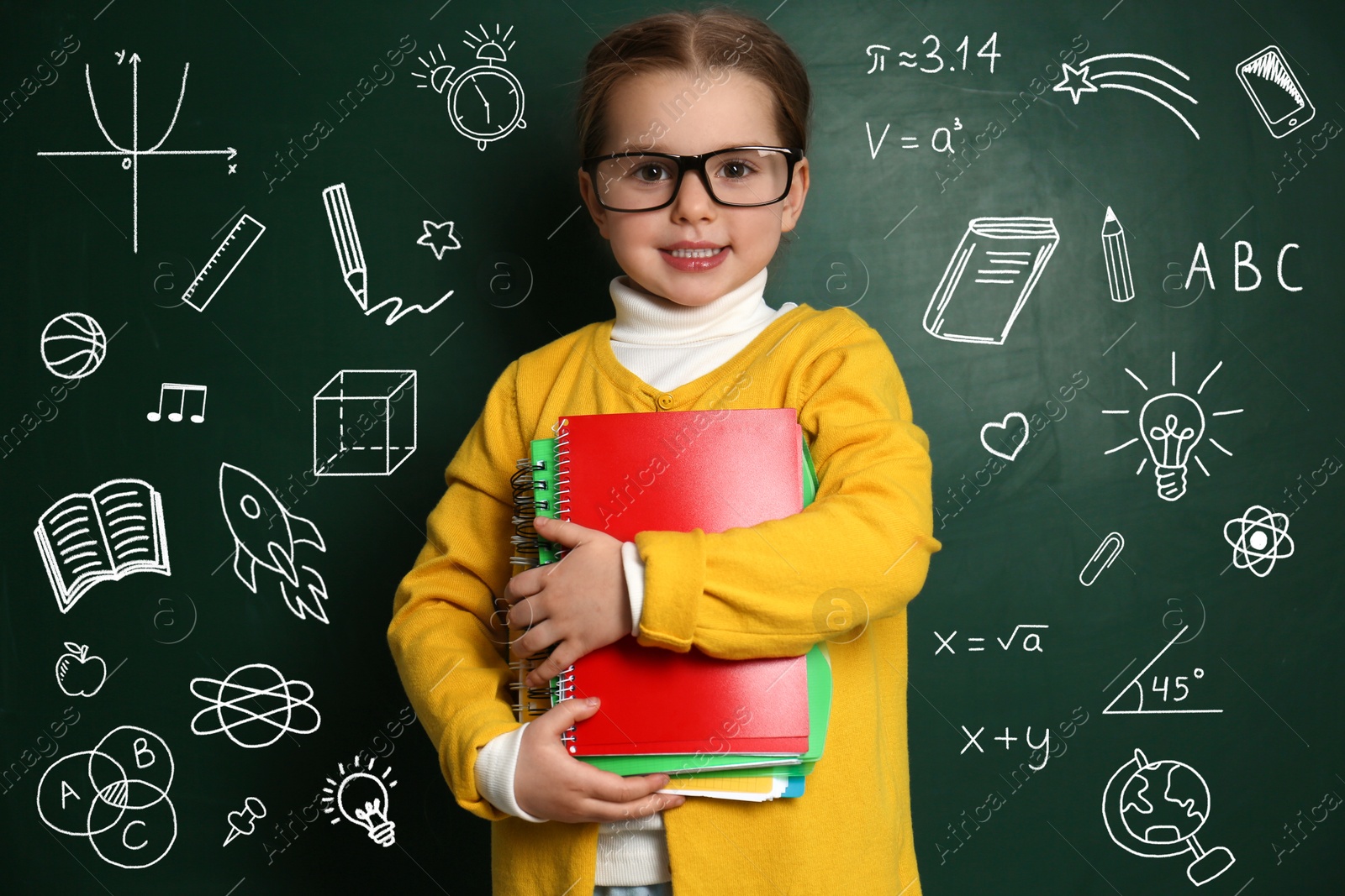 Image of Child wearing eyeglasses near green chalkboard with formulas and drawings