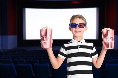 Image of Happy little boy with 3D glasses buckets of popcorn in cinema