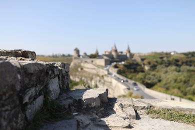 Photo of View of old castle on sunny day, focus on stone ruins
