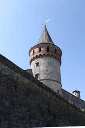Photo of Beautiful old building against light blue sky, low angle view