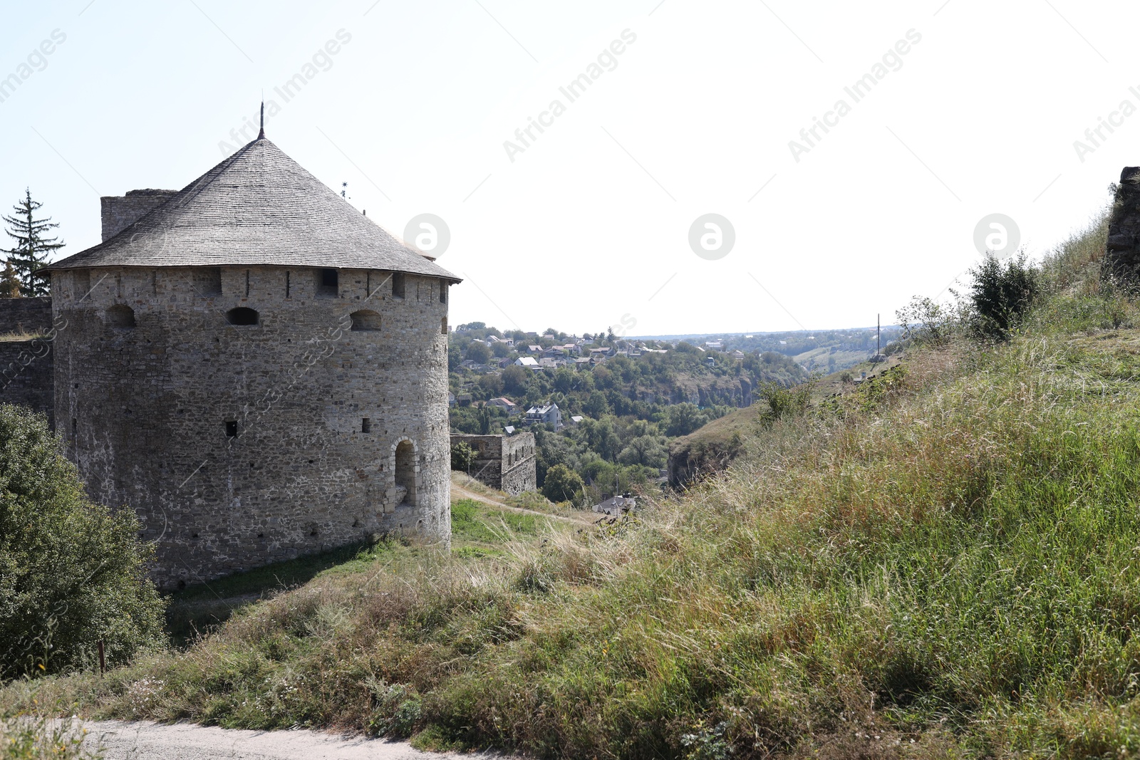 Photo of View of old stone tower on green hill