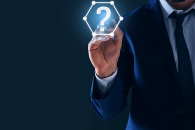 Image of Businessman touching question mark on virtual screen against dark background, closeup