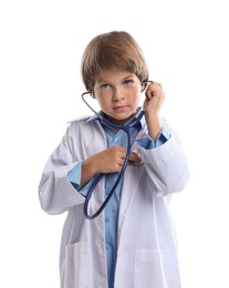 Photo of Choice of profession. Little boy in uniform with stethoscope pretending to be doctor on white background