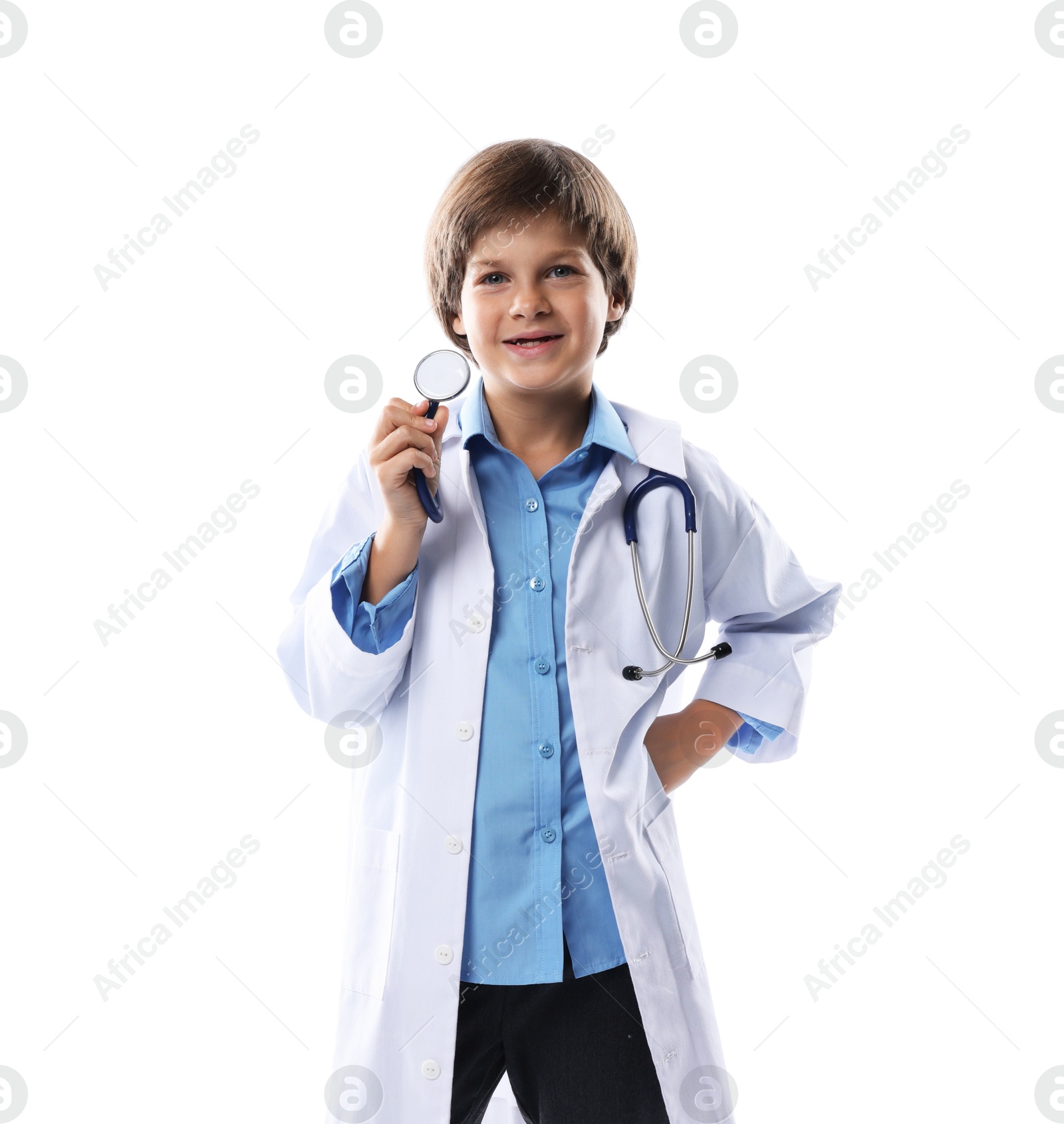 Photo of Choice of profession. Happy little boy in uniform with stethoscope pretending to be doctor on white background