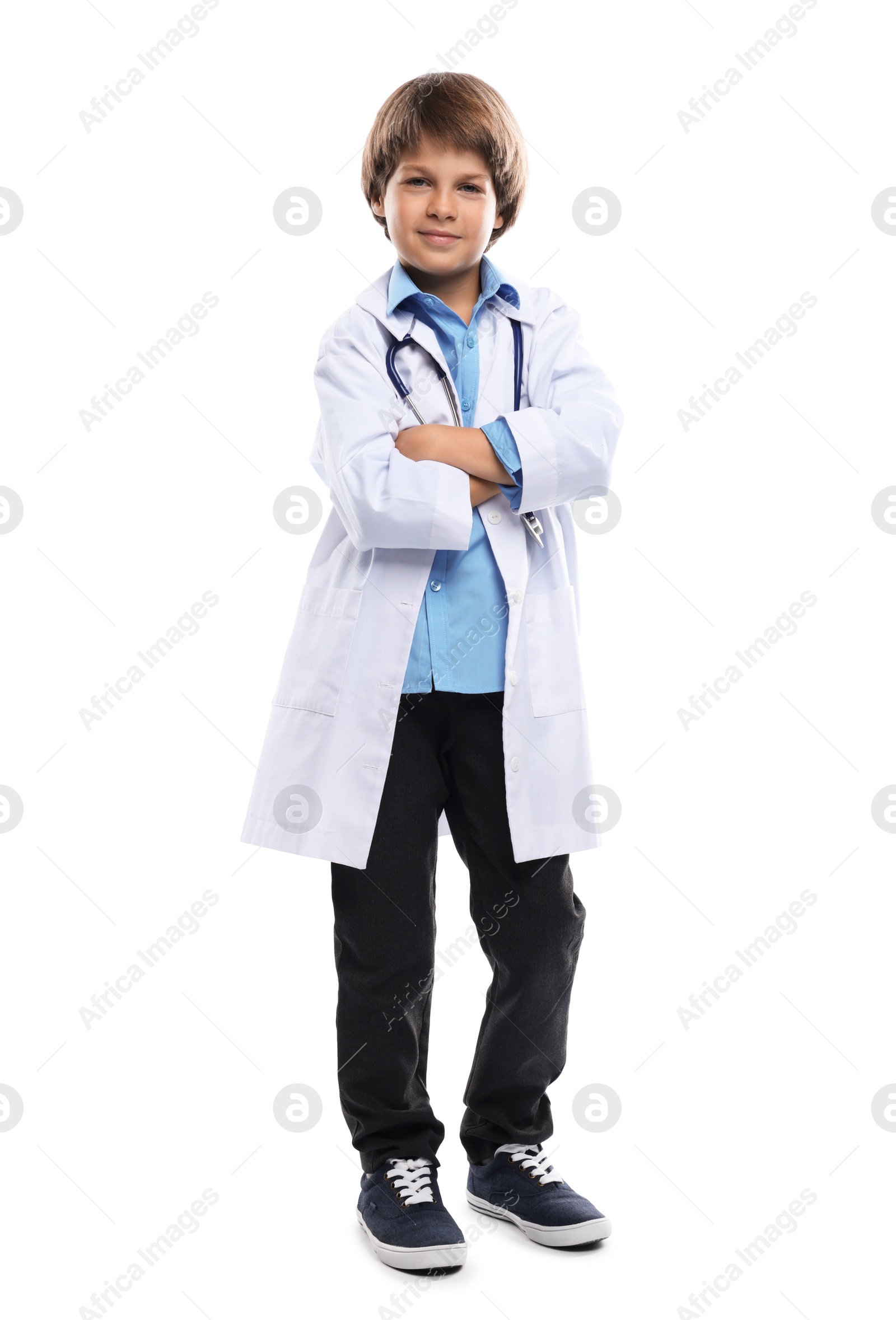 Photo of Choice of profession. Little boy in uniform with stethoscope pretending to be doctor on white background