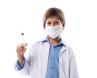 Photo of Choice of profession. Little boy in medical mask with syringe pretending to be doctor on white background