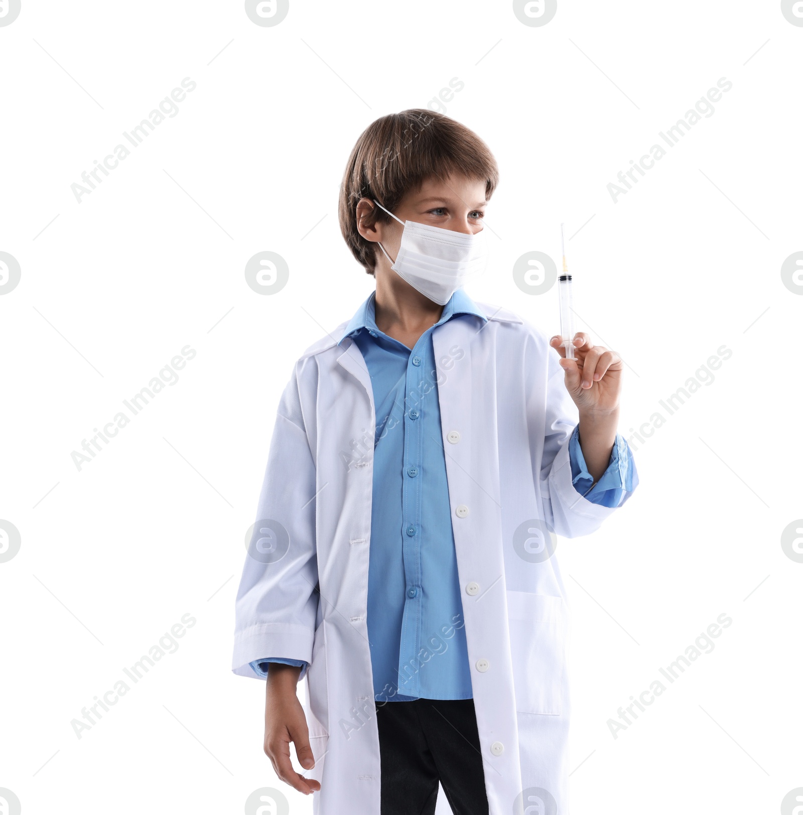 Photo of Choice of profession. Little boy in medical mask with syringe pretending to be doctor on white background