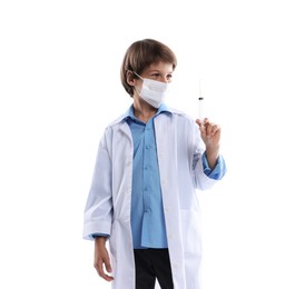 Photo of Choice of profession. Little boy in medical mask with syringe pretending to be doctor on white background