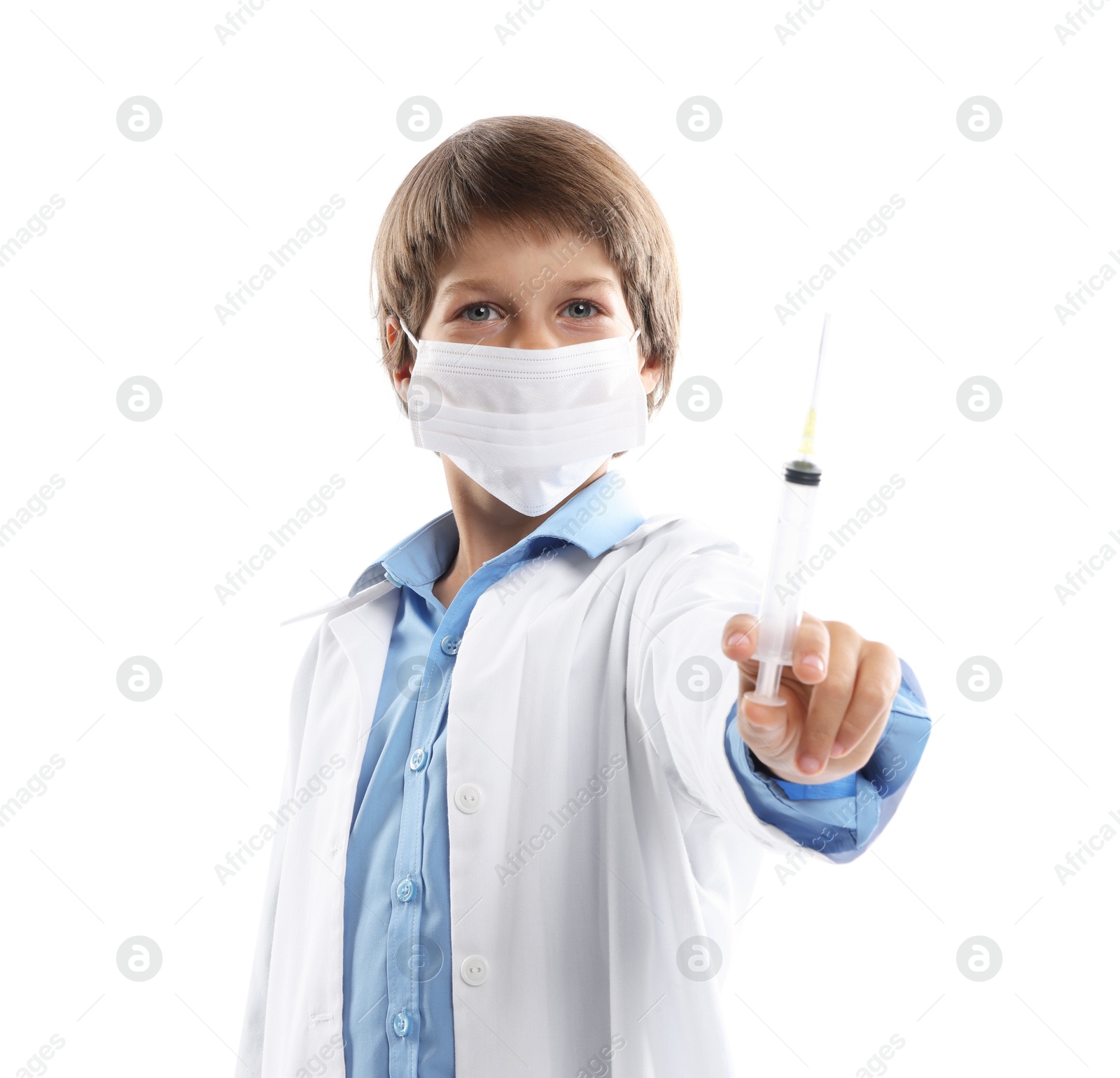 Photo of Choice of profession. Little boy in medical mask with syringe pretending to be doctor on white background