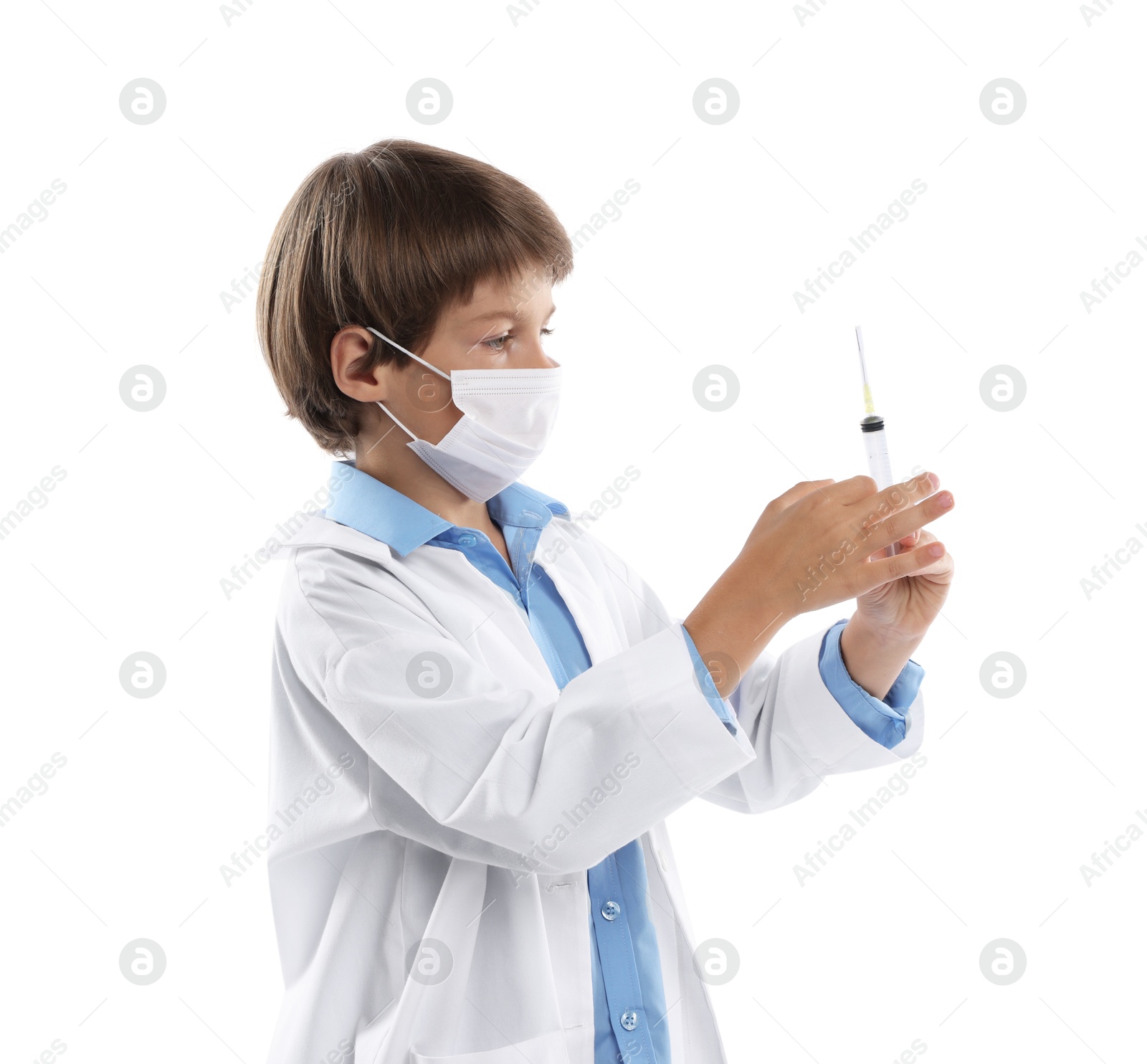 Photo of Choice of profession. Little boy in medical mask with syringe pretending to be doctor on white background