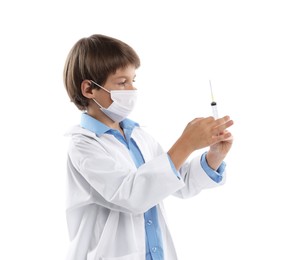 Photo of Choice of profession. Little boy in medical mask with syringe pretending to be doctor on white background