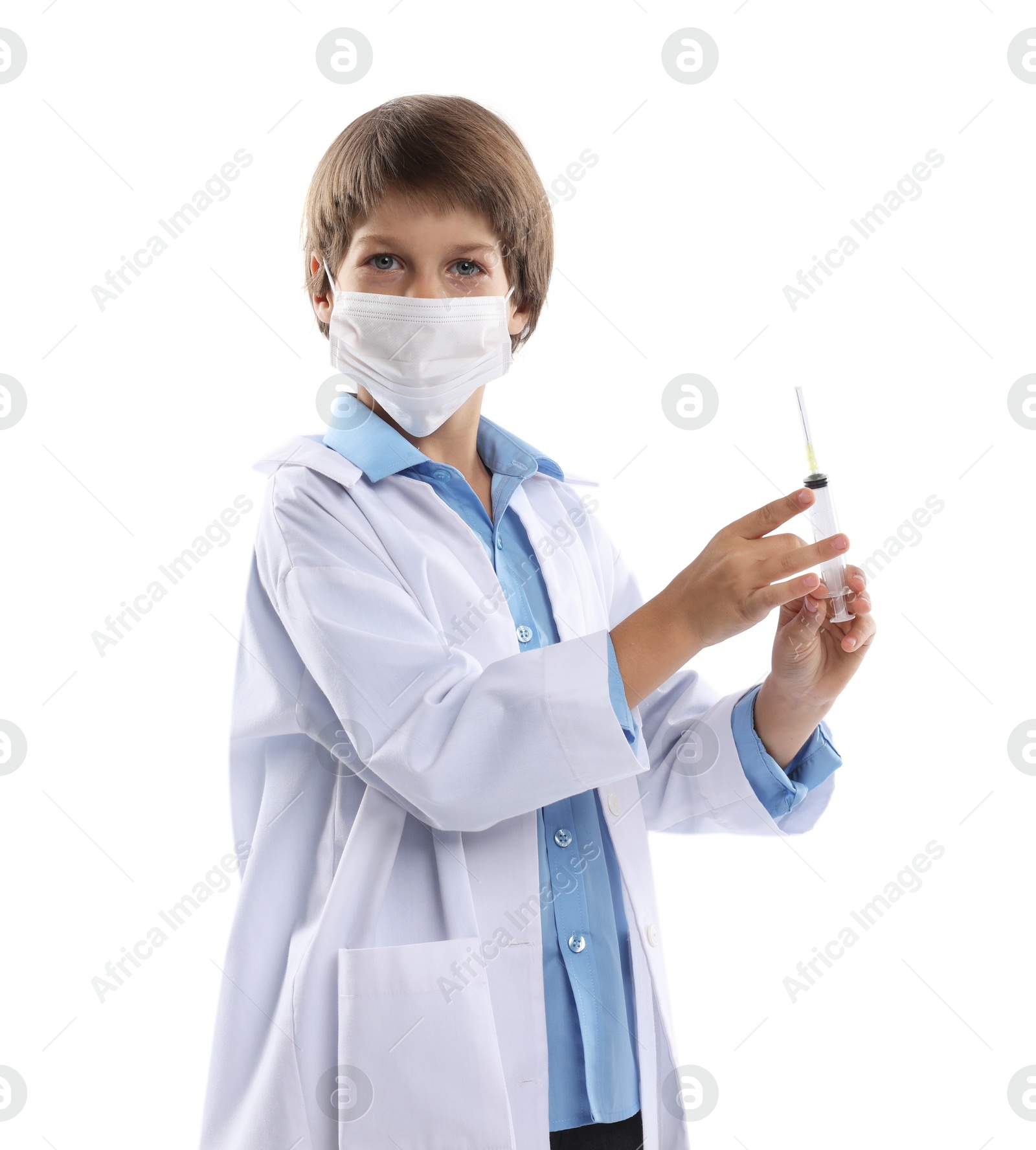 Photo of Choice of profession. Little boy in medical mask with syringe pretending to be doctor on white background