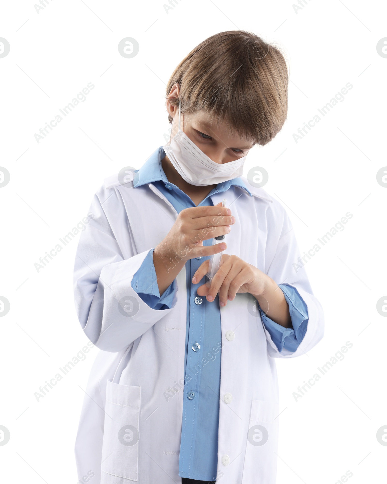 Photo of Choice of profession. Little boy in medical mask with syringe pretending to be doctor on white background
