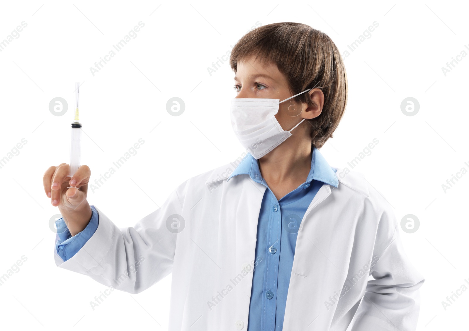 Photo of Choice of profession. Little boy in medical mask with syringe pretending to be doctor on white background