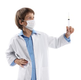 Photo of Choice of profession. Little boy in medical mask with syringe pretending to be doctor on white background